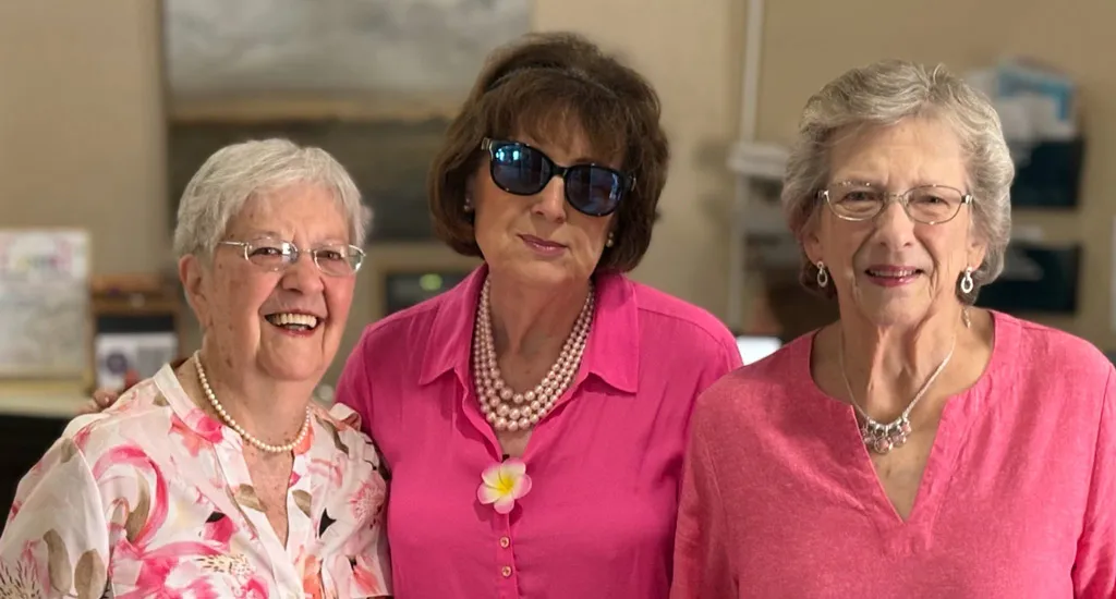ladies dressed in pink flowers
